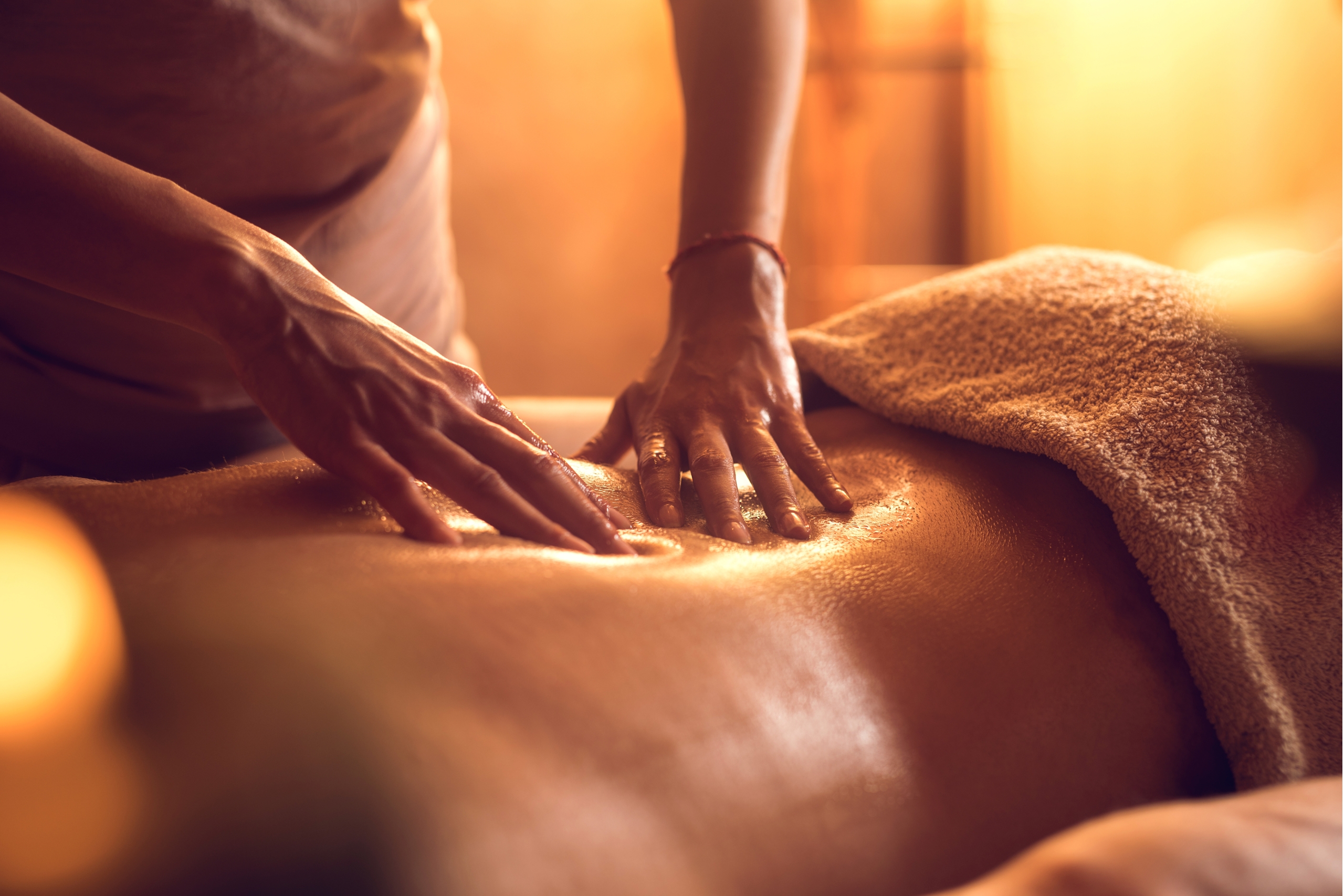 Unrecognizable massage therapist massaging man's back